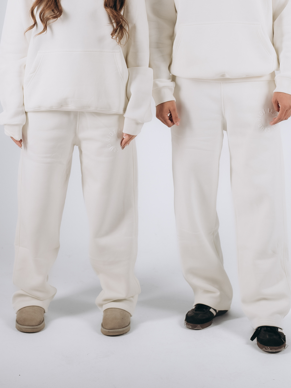 Unisex off-white relaxed-fit sweatpants paired with an oversized hoodie, designed for effortless comfort and minimalist style, made from premium fleece fabric."