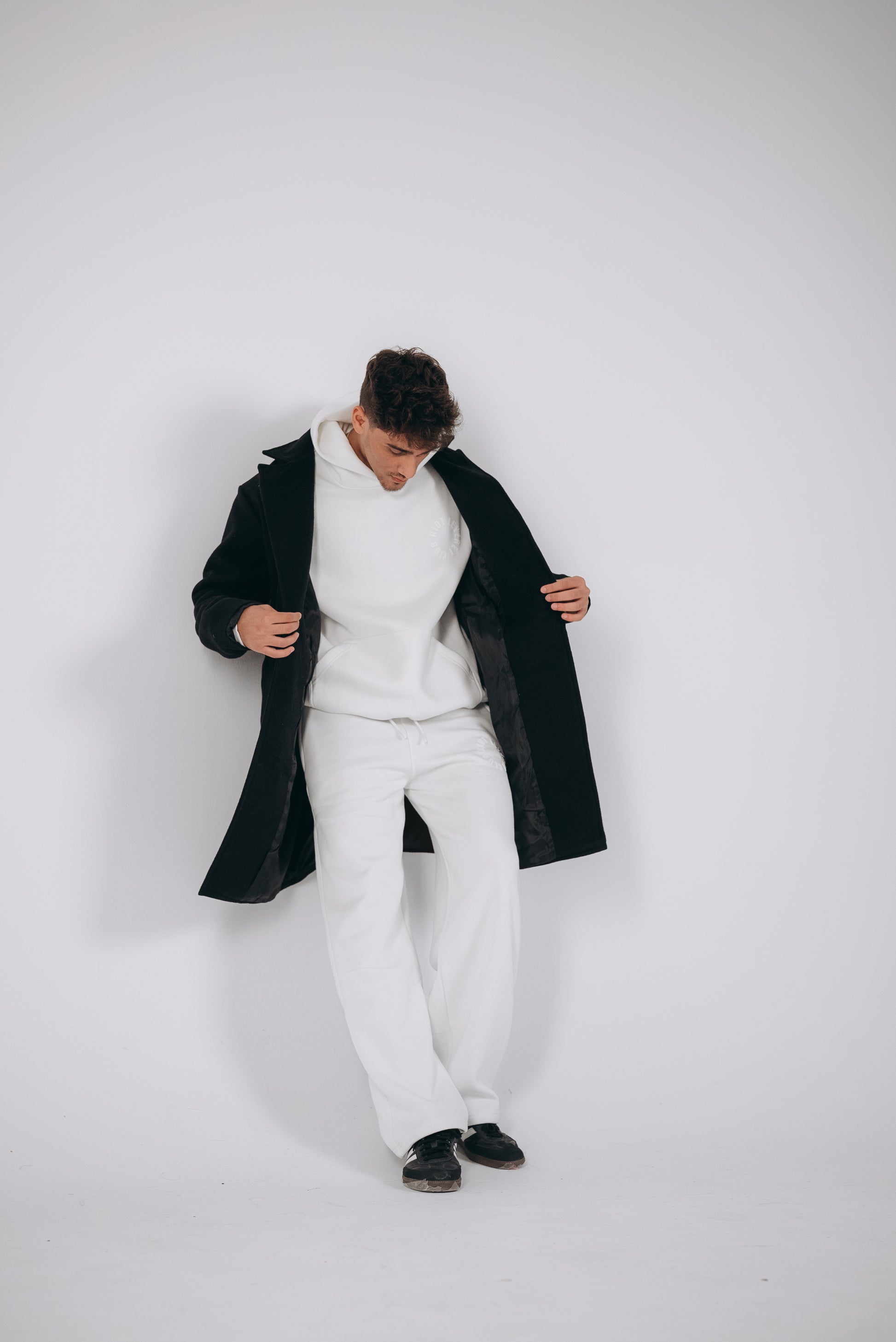 The young man model opened the coat showing his comfy white set